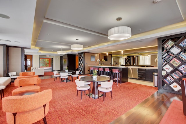 dining room featuring a tray ceiling and wood-type flooring