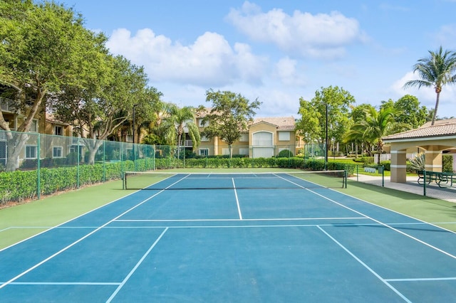 view of tennis court featuring basketball hoop