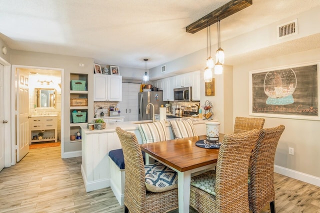 dining space with light wood-type flooring