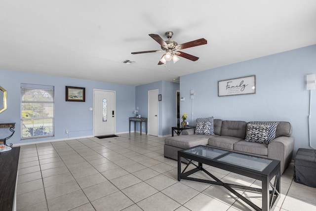 tiled living room featuring ceiling fan