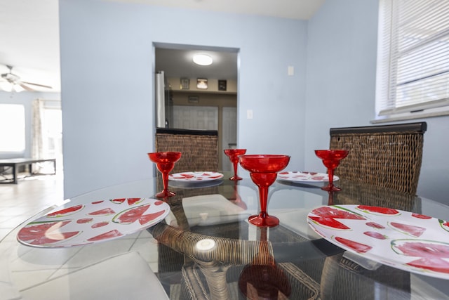 tiled dining room featuring ceiling fan