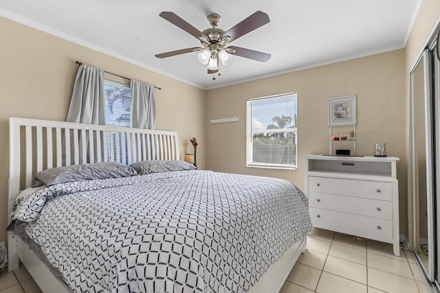 bedroom featuring ceiling fan, ornamental molding, and light tile patterned floors