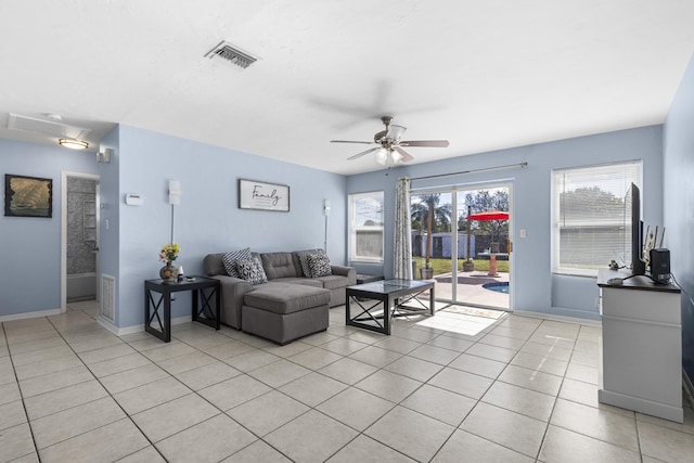 living room with ceiling fan, a healthy amount of sunlight, and light tile patterned flooring