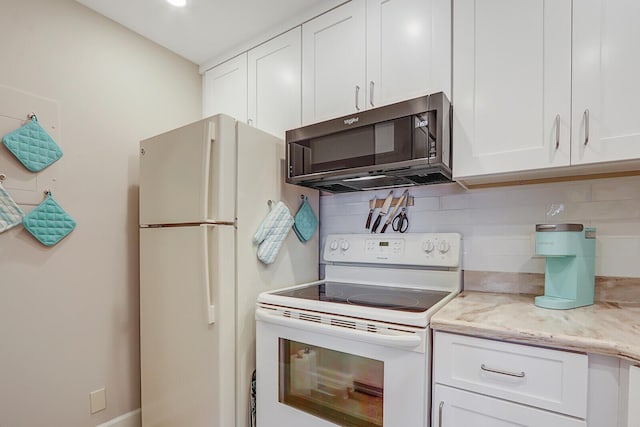 kitchen featuring backsplash, light stone countertops, white cabinets, and white appliances