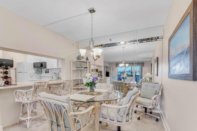 dining area featuring an inviting chandelier