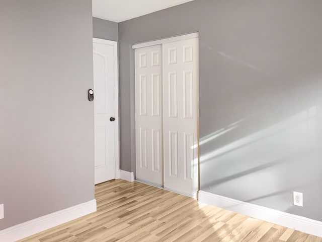 empty room with light hardwood / wood-style flooring