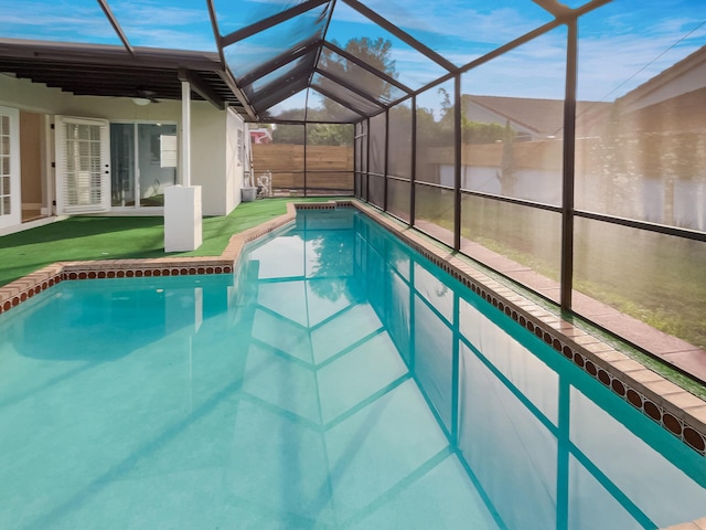 view of pool with ceiling fan and a lanai