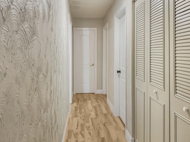 corridor with light wood-type flooring