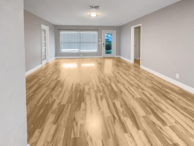 spare room with light hardwood / wood-style floors