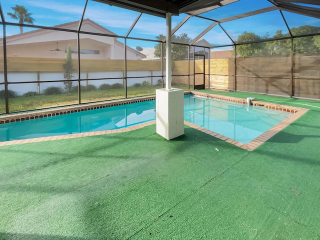 view of swimming pool featuring a lanai