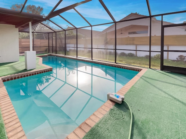 view of swimming pool featuring glass enclosure