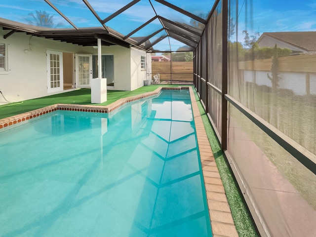 view of pool featuring glass enclosure and french doors