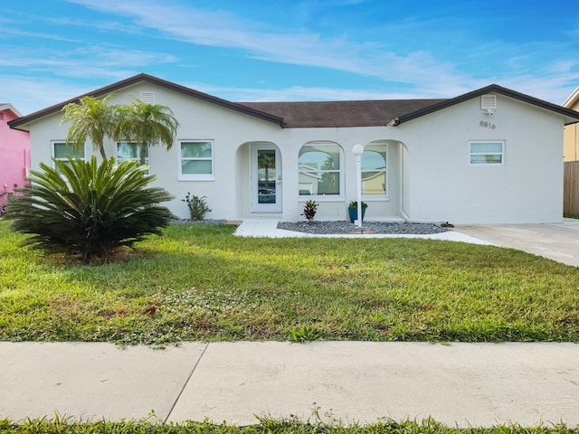 ranch-style home with a front lawn