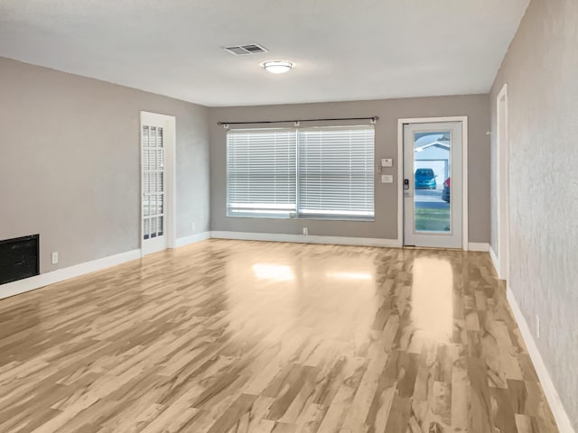 unfurnished living room featuring light hardwood / wood-style flooring