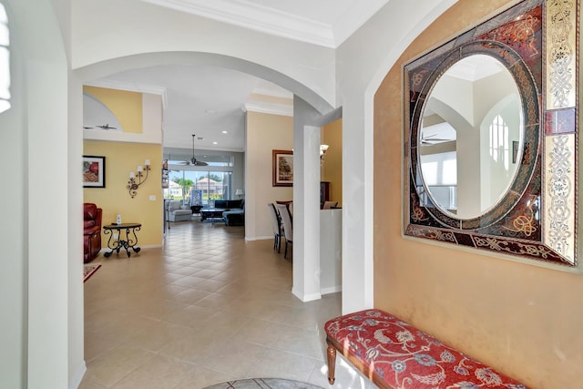 hallway featuring light tile patterned floors and ornamental molding