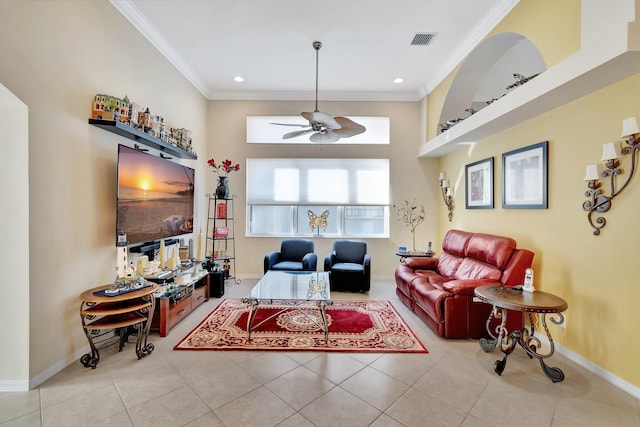 tiled living room with ceiling fan and ornamental molding