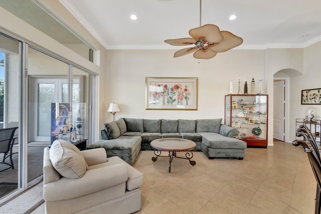 tiled living room with ceiling fan and crown molding