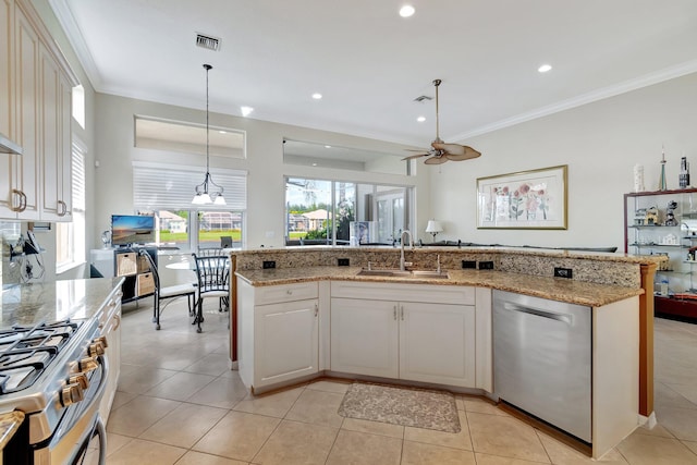 kitchen featuring sink, stainless steel appliances, decorative light fixtures, light tile patterned flooring, and ceiling fan with notable chandelier