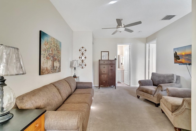 carpeted living room featuring ceiling fan