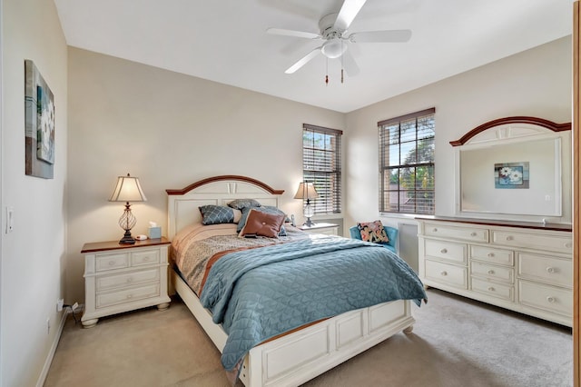 bedroom with ceiling fan and light colored carpet