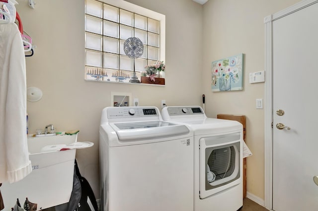 clothes washing area with washer and clothes dryer