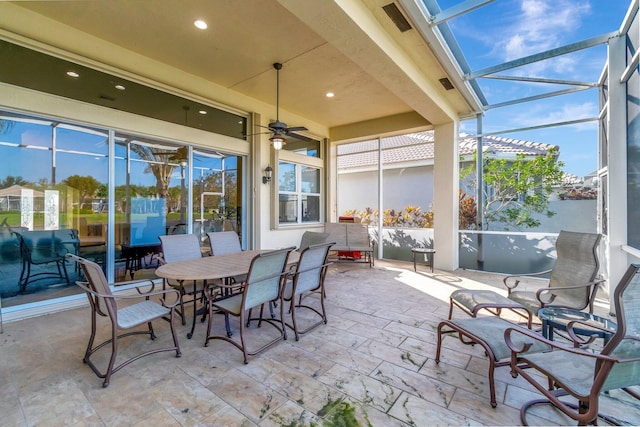 sunroom / solarium featuring ceiling fan