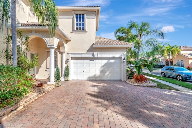 mediterranean / spanish-style house with a garage