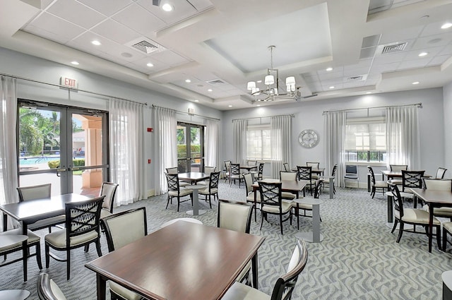 dining area with french doors, light colored carpet, and a notable chandelier