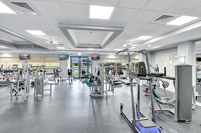 gym featuring a drop ceiling and ceiling fan