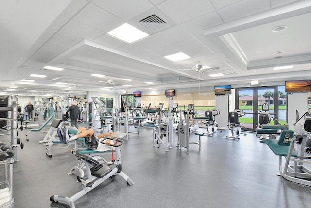 exercise room with a paneled ceiling and ceiling fan