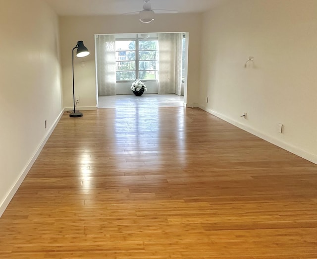 unfurnished room featuring light wood-type flooring and ceiling fan