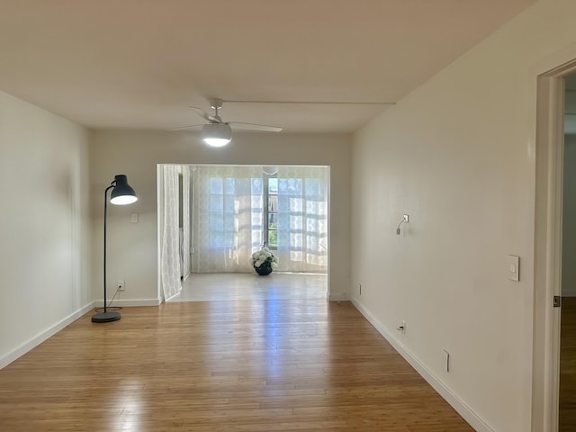 empty room featuring ceiling fan and light hardwood / wood-style flooring