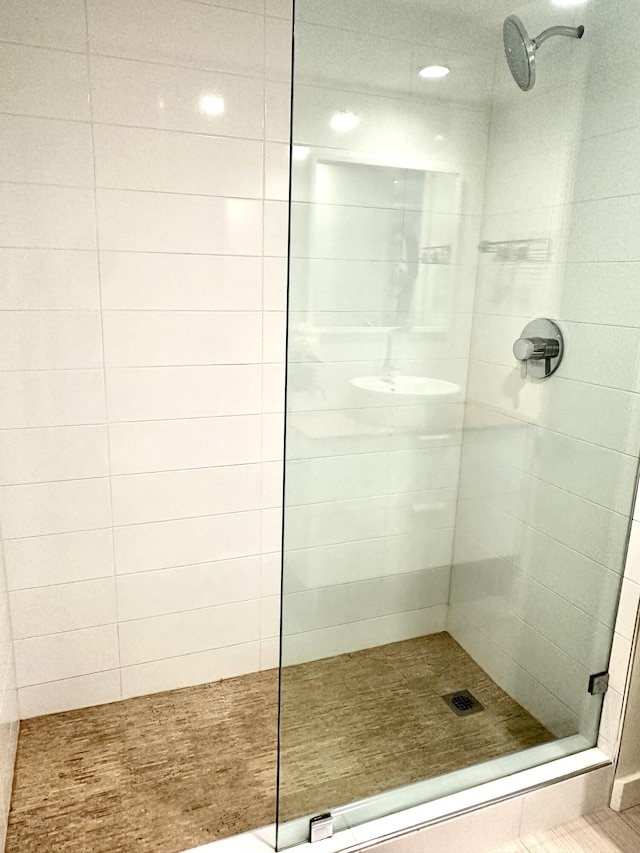 bathroom featuring tiled shower and tile patterned floors