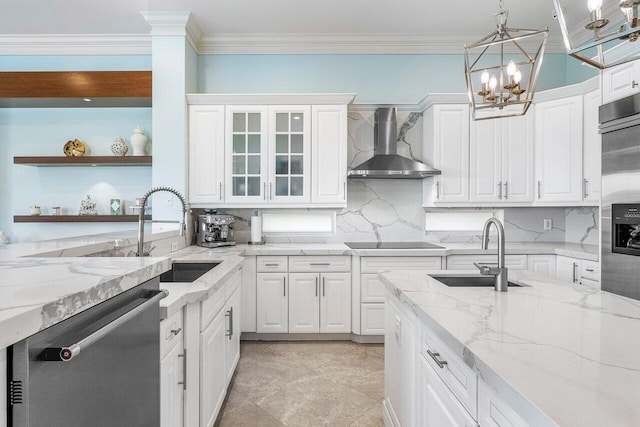 kitchen featuring white cabinets, sink, wall chimney range hood, dishwasher, and hanging light fixtures