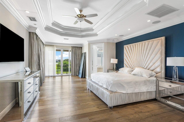 bedroom featuring hardwood / wood-style floors, access to outside, crown molding, ceiling fan, and a tray ceiling