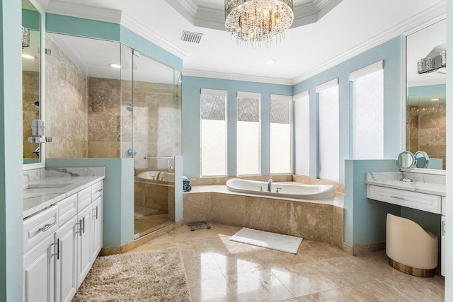 bathroom featuring an inviting chandelier, separate shower and tub, a tray ceiling, vanity, and ornamental molding