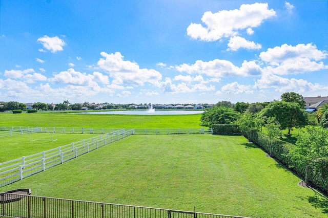 view of yard featuring a rural view and a water view