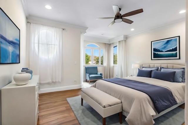 bedroom featuring ceiling fan, crown molding, and light hardwood / wood-style floors