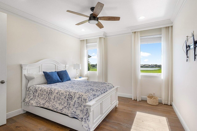 bedroom featuring ceiling fan, ornamental molding, and light wood-type flooring