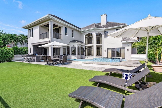 back of property featuring a patio area, a yard, and area for grilling