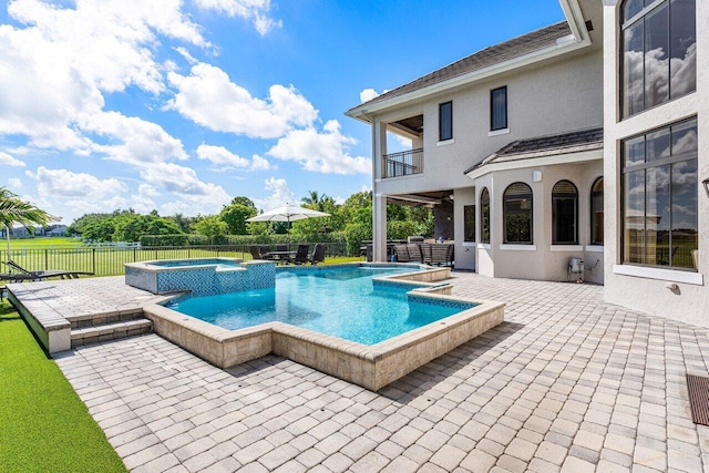 view of pool featuring a patio and a hot tub