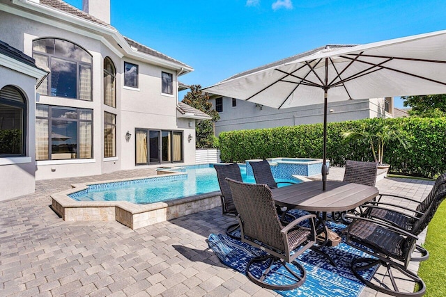 view of swimming pool featuring an in ground hot tub and a patio