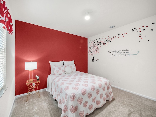 carpeted bedroom featuring visible vents and baseboards