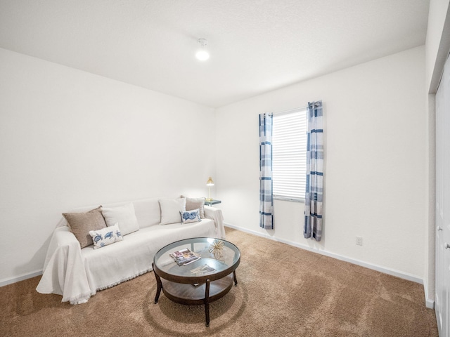 carpeted living room featuring baseboards