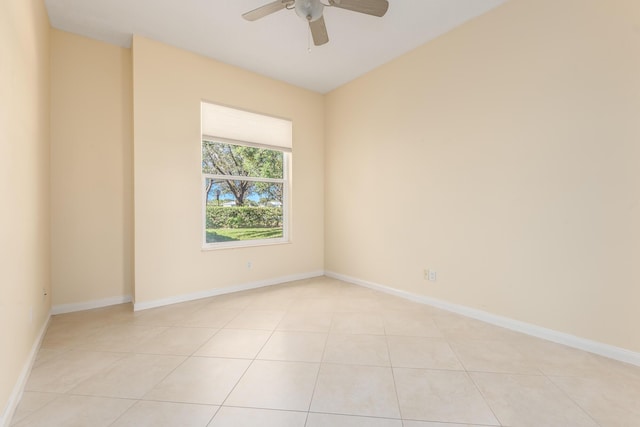 spare room with ceiling fan and light tile patterned flooring