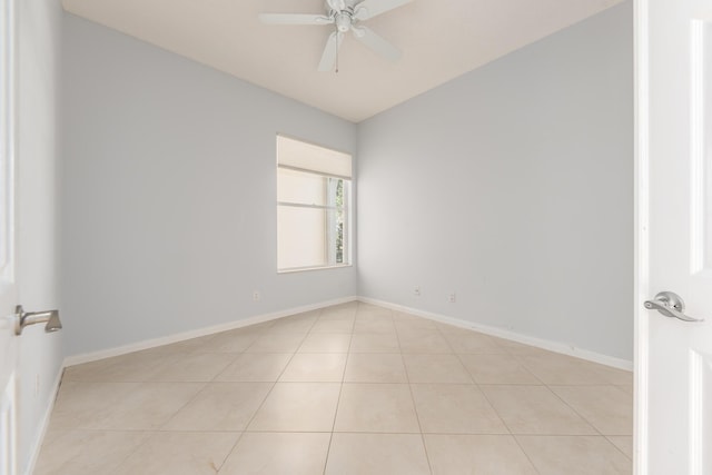 empty room with lofted ceiling, light tile patterned floors, and ceiling fan