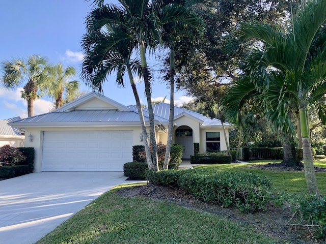 single story home with a garage and a front lawn