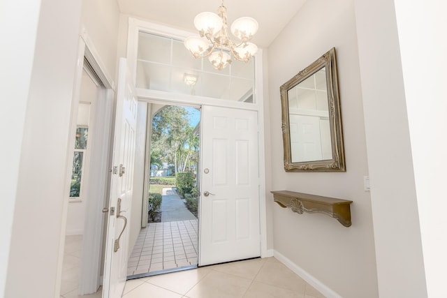 foyer entrance featuring an inviting chandelier and light tile patterned flooring