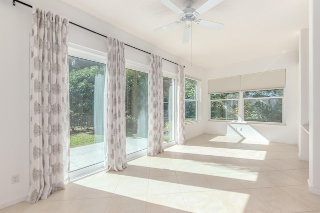 unfurnished sunroom featuring ceiling fan