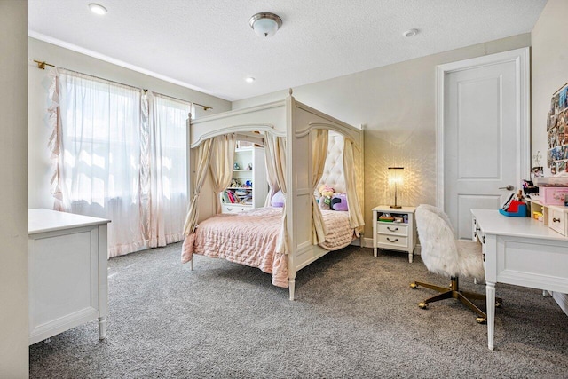 bedroom featuring dark colored carpet and a textured ceiling